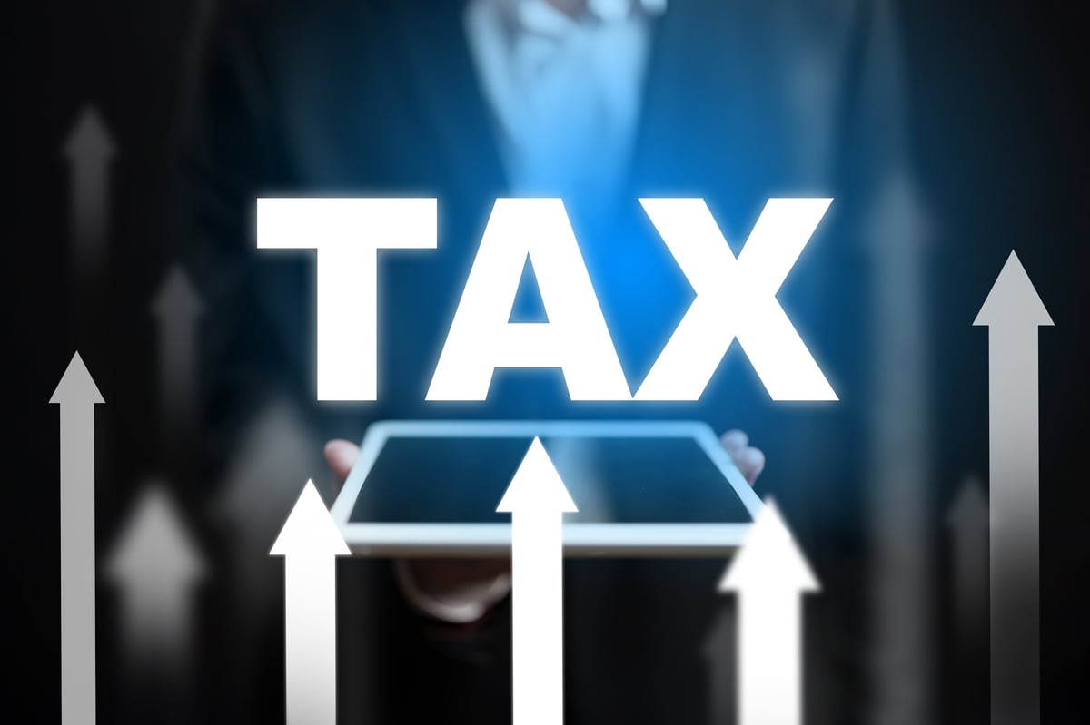 Business professionals analyze tax implications for enhancing economic growth strategies